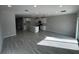 Spacious living room with wood-look tile floors, recessed lighting, and an open floor plan at 5086 Rain Shadow Dr, St Cloud, FL 34772