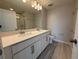 Bathroom with double vanity, framed mirrors, wood-style tile flooring, and great lighting at 5086 Rain Shadow Dr, St Cloud, FL 34772