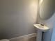 Modern powder room featuring a pedestal sink and stylish finishes at 5086 Rain Shadow Dr, St Cloud, FL 34772