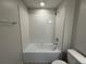 Bright white tiled bathroom with shower and bathtub combo at 5086 Rain Shadow Dr, St Cloud, FL 34772