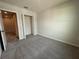 Carpeted bedroom with closet and access to other rooms of the home at 5086 Rain Shadow Dr, St Cloud, FL 34772