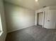 A bedroom with closet and interior doors, neutral paint and modern gray carpet at 5086 Rain Shadow Dr, St Cloud, FL 34772