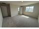 Bedroom featuring carpet, a double window with backyard views, and neutral walls at 5086 Rain Shadow Dr, St Cloud, FL 34772