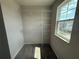 A walk-in closet with multiple shelves and a window offering natural light at 5086 Rain Shadow Dr, St Cloud, FL 34772