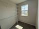 A walk-in closet with multiple shelves and a window offering natural light at 5086 Rain Shadow Dr, St Cloud, FL 34772