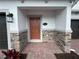 Inviting front entrance featuring brick walkway and stone accents at 5086 Rain Shadow Dr, St Cloud, FL 34772