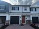 Charming two-story townhome featuring a well-manicured brick entryway and a convenient attached garage at 5086 Rain Shadow Dr, St Cloud, FL 34772