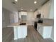 Modern kitchen features white cabinets, stainless steel appliances, and an island with a sink at 5086 Rain Shadow Dr, St Cloud, FL 34772