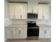 Kitchen with white cabinets, stainless steel appliances, and granite countertops at 5086 Rain Shadow Dr, St Cloud, FL 34772