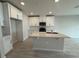 Modern kitchen with sleek countertops, white cabinets, stainless steel appliances, and a functional island at 5086 Rain Shadow Dr, St Cloud, FL 34772