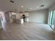 Bright, open living area with wood-look tile floors and a modern kitchen at 5086 Rain Shadow Dr, St Cloud, FL 34772