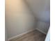 Storage area with wood-look tile floor and an angled ceiling at 5086 Rain Shadow Dr, St Cloud, FL 34772