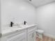 Bathroom with white cabinets, double sinks, and modern fixtures at 101 S Glenwood Ave, Orlando, FL 32803