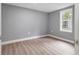 Simple bedroom with grey walls, wood-look flooring, and a window at 101 S Glenwood Ave, Orlando, FL 32803