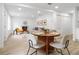 Open concept dining area with a round wooden table and modern chairs at 101 S Glenwood Ave, Orlando, FL 32803