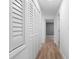 White hallway with wood-look floors, white shutters and doors to other rooms at 101 S Glenwood Ave, Orlando, FL 32803