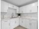 Modern white kitchen with quartz countertops and stainless steel sink at 101 S Glenwood Ave, Orlando, FL 32803