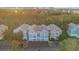 Condominium complex with colorful exteriors nestled among lush trees in a serene, suburban setting at 12843 Madison Pointe Cir # 107, Orlando, FL 32821