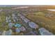 Scenic aerial view showcasing a community with a pool, set amidst lush greenery and distant city views at 12843 Madison Pointe Cir # 107, Orlando, FL 32821