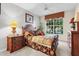 Cozy bedroom with a large window offering a bright and airy feel at 12843 Madison Pointe Cir # 107, Orlando, FL 32821