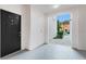 Inviting condo entrance featuring a black door, and a view of the neighborhood at 12843 Madison Pointe Cir # 107, Orlando, FL 32821