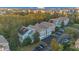 A complex features various exterior paint colors and solar panels in a tree lined community at 12843 Madison Pointe Cir # 107, Orlando, FL 32821