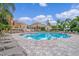 Community pool area with ample lounge chairs for relaxation at 12843 Madison Pointe Cir # 107, Orlando, FL 32821