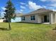 Spacious backyard with grassy lawn and a view of a neighboring house at 2243 Tay Wes Dr, Saint Cloud, FL 34771