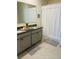 Bathroom featuring double sink vanity with granite countertop, neutral cabinets, and tiled floors at 2243 Tay Wes Dr, Saint Cloud, FL 34771