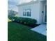 Close-up of front yard featuring green grass, mulch beds, and manicured shrubbery at 2243 Tay Wes Dr, Saint Cloud, FL 34771