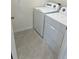 Convenient laundry room with washer and dryer, and neutral tile flooring at 2243 Tay Wes Dr, Saint Cloud, FL 34771