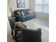 Living room featuring a plush blue sofa with decorative pillows and stylish grey accent chairs at 2243 Tay Wes Dr, Saint Cloud, FL 34771