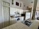 Well-equipped kitchen with white cabinets at 2520 Woodgate Blvd # 202, Orlando, FL 32822