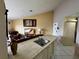 Kitchen with breakfast bar and white cabinets at 2520 Woodgate Blvd # 202, Orlando, FL 32822