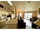 Open concept kitchen and living area with water view at 2520 Woodgate Blvd # 202, Orlando, FL 32822