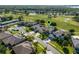 Aerial view of a neighborhood, surrounded by a golf course and multiple ponds, with mature landscaping and trees at 9918 Turtle Bay Ct, Orlando, FL 32832