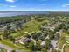 Beautiful aerial view of a community with a golf course, ponds, and other landscaping with a lake in the background at 9918 Turtle Bay Ct, Orlando, FL 32832