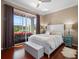 A bedroom with a king-size bed and a view of the outdoors, creating a serene retreat at 9918 Turtle Bay Ct, Orlando, FL 32832