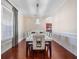 Formal dining room features hardwood floors, neutral paint, and modern chandelier at 9918 Turtle Bay Ct, Orlando, FL 32832