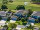 A two-story home with attached garages on a golf course with mature palm trees and a well manicured lawn at 9918 Turtle Bay Ct, Orlando, FL 32832