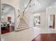 Spacious foyer with staircase, tile flooring, and an arched entryway at 9918 Turtle Bay Ct, Orlando, FL 32832