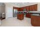 Well-equipped kitchen with stainless steel appliances, dark wood cabinets, and tile flooring at 9918 Turtle Bay Ct, Orlando, FL 32832