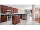 Modern kitchen with stainless steel appliances, dark wood cabinets, and center island at 9918 Turtle Bay Ct, Orlando, FL 32832