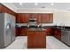 A kitchen with stainless steel appliances and dark wood cabinets, offering style and functionality at 9918 Turtle Bay Ct, Orlando, FL 32832