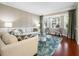 Stylish living room features hardwood floors, neutral paint, and bright window at 9918 Turtle Bay Ct, Orlando, FL 32832