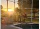 Sunset view from relaxing pool area with lush landscape at 9918 Turtle Bay Ct, Orlando, FL 32832