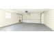 A spacious garage with a clean, painted floor and a white garage door at 103 Bonita Pl, Ormond Beach, FL 32174