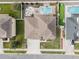 Aerial view of a house with a pool, putting green, and landscaped yard at 1316 Fountain Hills Ct, Winter Park, FL 32792