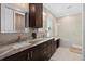 Double vanity bathroom with granite countertop and large shower at 1316 Fountain Hills Ct, Winter Park, FL 32792