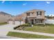 Two-story house with three-car garage, landscaped yard, and stone accents at 1316 Fountain Hills Ct, Winter Park, FL 32792